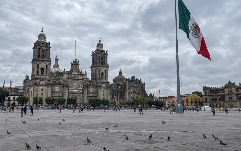 The Zócalo plaza with the Metropolitan Cathedral and a large Mexican flag in Centro Histórico